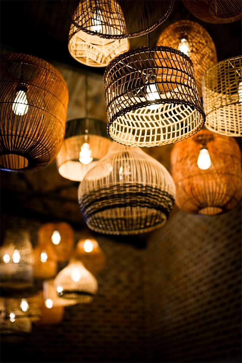 Rattan lamps glowing over the restaurant tables